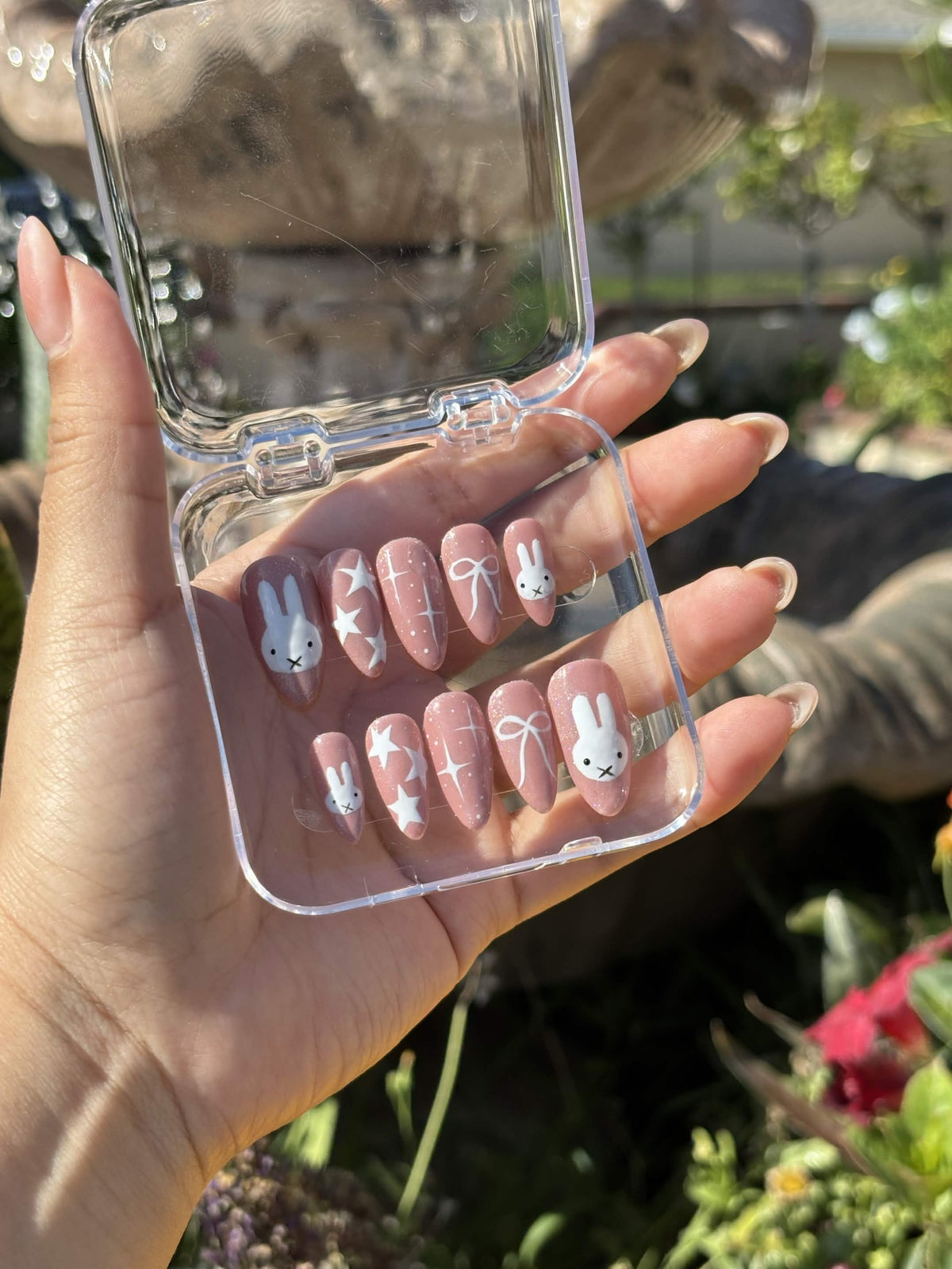 A Moonlight Kitty set painted by hand — mauve shimmer almond nails